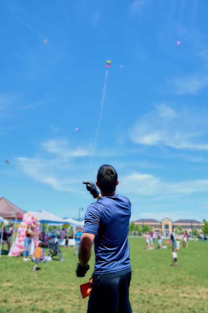 a young man flying a kite at the festival in Utah